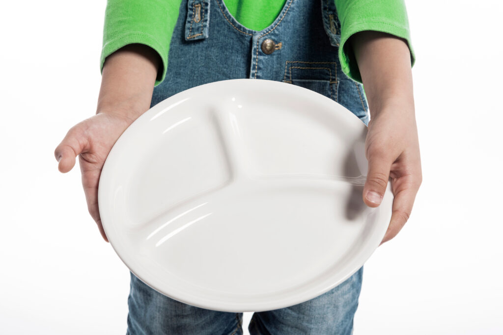 Child holding out empty plate